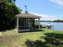 14' x 14' vinyl pavilion with slider screens by lake